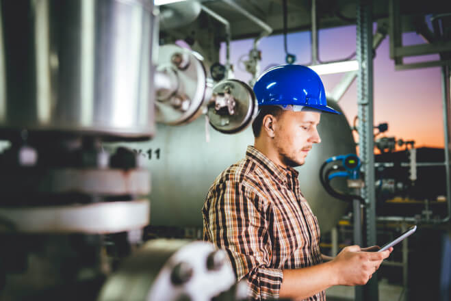Man using tablet at Natural gas processing facility