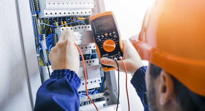 Technician performing failure finding maintenance on an electrical panel